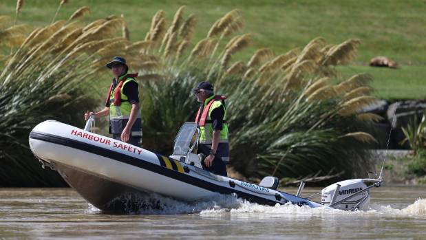 Search and rescue teams scour the Hutt River for the missing swimmer on Friday.