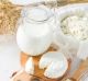 Fresh dairy products (milk, cottage cheese), wheat, white wood background