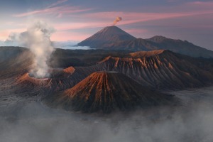 A view of Mount Bromo and Mount Semeru spewing ashes while Mount Batok remains inactive in the island of Jawa, Indonesia.