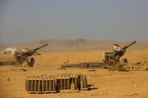 Lebanese national flags are set on the top of cannons inside a base during a media trip organized by the Lebanese army, on the outskirts of Ras Baalbek, northeast Lebanon, Monday, Aug. 28, 2017.