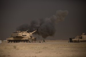 A U.S. Army M109A6 Paladin conducts a fire mission at Qayyarah West, Iraq, in support of the Iraqi security forcesâ push toward Mosul, Oct. 17, 2016.