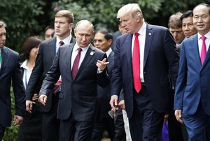 U.S. President Donald Trump, center right, and Russia's President Vladimir Putin, center left, talk during the family photo session at the APEC Summit in Danang, Saturday, Nov. 11, 2017.