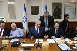 Israeli Prime Minister Benjamin Netanyahu, center, chairs the weekly cabinet meeting at his office in Jerusalem, Sunday, Nov. 12, 2017.