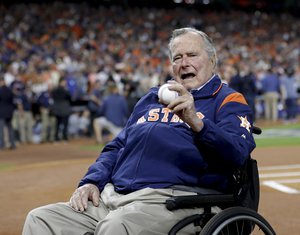 Former President George H.W. Bush waits on the field for first pitch ceremony before Game 5 of baseball's World Series against the Los Angeles Dodgers Sunday, Oct. 29, 2017, in Houston.