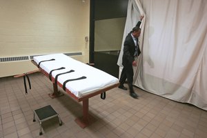 In this November 2005 file photo, Larry Greene, public information director of the Southern Ohio Correctional Facility, demonstrates how a curtain is pulled between the death chamber and witness room at the prison in Lucasville, Ohio. With Ohio’s next execution scheduled for Wednesday, Nov. 15, 2017, the state has sufficiently replenished its lethal drug supply to carry out nearly 20 executions under certain conditions, according to records obtained by The Associated Press. (AP Photo/Kiichiro Sato, File)