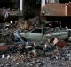 A car lays smashed by debris from the earthquake at the city of Sarpol-e-Zahab in western Iran on Monday.