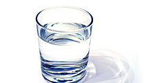 water glass on white background. (drink; clear; clean water; liquid)