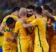 Job done: Mile Jedinak is mobbed after scoring.