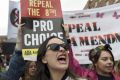 Demonstrators take part in a protest to urge the Irish Government to repeal the 8th amendment to the constitution, which ...