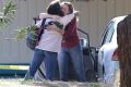 Two women embrace outside Rancho Tehama Elementary School, where a gunman opened fire but didn't kill anyone due to the ...