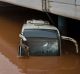 People are reflected in the front window of a flooded bus as water engulfs an interchange of a highway in Elefsina, ...