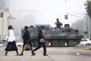 AN armed soldier patrols a street in Harare, Wednesday, Nov. 15, 2017. In the wake of the military takeover in Zimbabwe, the national police force has recalled all officers on leave.