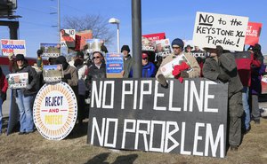 Demonstrators opposing the Keystone XL oil pipeline hold banners outside the office of Rep. Brad Ashford, D-Neb., in Omaha, Neb., Tuesday, Jan. 13, 2015.