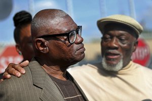 Wilbert Jones talks to media with his brother Plem Jones, right, after leaving East Baton Rouge Parish Prison in Baton Rouge, La., Wednesday, Nov. 15, 2017. The Louisiana man who has spent nearly 50 years in prison was freed after a judge overturned his conviction in the kidnapping and rape of a nurse. State District Court Judge Richard Anderson threw out Jones' conviction on Oct. 31, saying authorities withheld evidence that could have exonerated Jones decades ago. (AP Photo/Gerald Herbert)