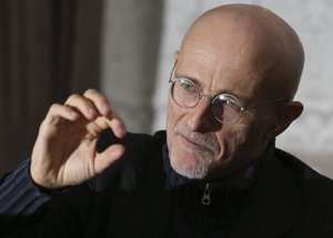 Professor Sergio Canavero gestures as he speaks to the media during a press conference in Glasgow, Scotland, Friday Nov. 18, 2016.