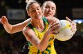 Australian goal shooter Caitlin Bassett holds off Silver Fern defender Kelly Jury in Adelaide on Wednesday night.