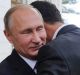 Russian President Vladimir Putin, left, embraces Syrian President Bashar Assad in Sochi on Monday.