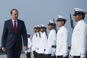 Australian Minister of Immigration and Border Protection, Peter Dutton inspects a guard of honor during a ceremony to mark the arrival and official naming of the first Malaysia Maritime Enforcement Agency bay class vessel at the National Hydrographic Centre in Port Klang, outside Kuala Lumpur, Malaysia on Friday, Feb. 27, 2015. The ceremony marks the official hand over of one of the two bay class vessels from the government of Australia to Malaysia. (AP Photo/Joshua Paul)