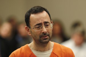 Dr. Larry Nassar appears in court for a plea hearing in Lansing, Mich., Wednesday, Nov. 22, 2017