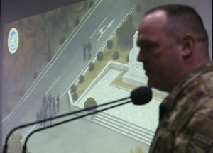 Col. Chad G. Carroll, a spokesman for the U.N. command, shows the CCTV footage regarding a North Korean soldier's defection during a press conference at the Defense Ministry in Seoul, South Korea, Wednesday, Nov. 22, 2017.