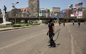 An Egyptian police officer stands guards at Sphinx Square in Cairo, Egypt, Friday, Aug. 30, 2013