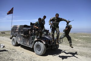 In this April 14, 2017, file photo, Afghan commandos arrive at Pandola village near the site of a U.S. bombing in the Achin district of Jalalabad, east of Kabul, Afghanistan.