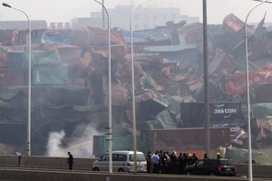 Chinese emergency crew survey the site of an explosion in northeastern China's Tianjin municipality Saturday, Aug. 15, 2015. New explosions and fire rocked the Chinese port city of Tianjin on Saturday.