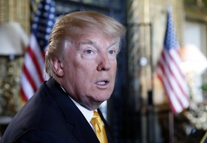 In this Thursday, Nov. 23, 2017 file photo, President Donald Trump speaks to the media before speaking with members of the armed forces via video conference at his private club, Mar-a-Lago, on Thanksgiving in Palm Beach, Fla.