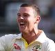 Finding his groove: Australia and Josh Hazlewood celebrate his dismissal of James Vince for two runs.