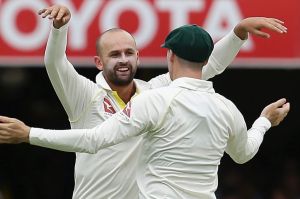 Australia's Nathan Lyon, left, celebrates with teammate Peter Handscomb after getting the wicket of England's Dawid ...