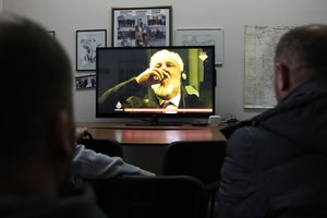 Bosnian people watch the live TV broadcast from the International Criminal Court for the former Yugoslavia (ICTY) in The Hague as Slobodan Praljak brings a bottle to his lips, in southern Bosnian town of Mostar 140 kms south of Sarajevo, on Wednesday, Nov. 29, 2017.