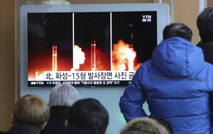 People watch a TV screen showing a local news program reporting about North Korea's missile launch, at the Seoul Railway Station in Seoul, South Korea, Thursday, Nov. 30, 2017.