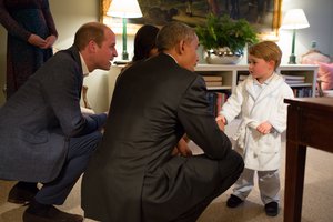 President Barack Obama with First Lady Michelle Obama meets Prince George as the Duke and Duchess of Cambridge watch at Kensington Palace in London, April 22, 2016.