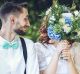 Couple on wedding day sitting and holding flowers