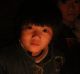 "My hands are OK but my feet are cold a little bit," says Xu Yuanyuan, 7, who is trying to study by candlelight.