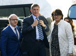 Former Trump national security adviser Michael Flynn, center, arrives at federal court in Washington, Friday, Dec. 1, 2017.