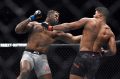 Francis Ngannou (left) hits Alistair Overeem in the first round of their UFC 218 heavyweight bout.