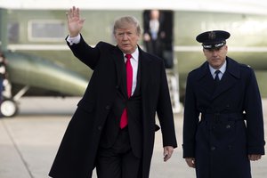 President Donald Trump waves as he boards Air Force One for a trip to Salt Lake City, Monday, Dec. 4, 2017, in Andrews Air Force Base, Md.