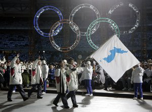 In this Feb. 10, 2006 file photo, Korea flag-bearers Bora Lee and Jong-In Lee, carrying a unification flag, lead their teams into the stadium during the 2006 Winter Olympics opening ceremony in Turin, Italy.