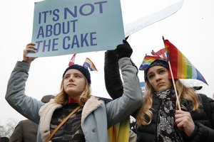 Lydia Macy, 17, left, and Mira Gottlieb, 16, both of Berkeley, Calif., rally outside of the Supreme Court which is hearing the 'Masterpiece Cakeshop v. Colorado Civil Rights Commission' today, Tuesday, Dec. 5, 2017, in Washington.