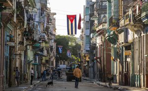 Cuban flags hang across a street in Havana, Cuba, Saturday, Aug. 13, 2016.