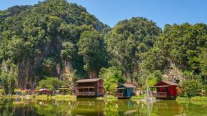 Wooden houses on Ipoh Lake, Malaysia. The limestone outcrops just outside town are reminiscent of Halong Bay in Vietnam.