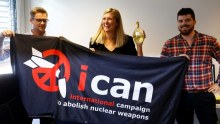 International Campaign to Abolish Nuclear Weapons hold banner. 