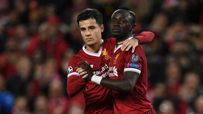 Liverpool's Senegalese midfielder Sadio Mane (R) celebrates scoring their sixth goal with Liverpool's Brazilian midfielder Philippe Coutinho (L) during the UEFA Champions League Group E football match between Liverpool and Spartak Moscow at Anfield in Liverpool, north-west England on December 6, 2017. / AFP PHOTO / Paul ELLIS