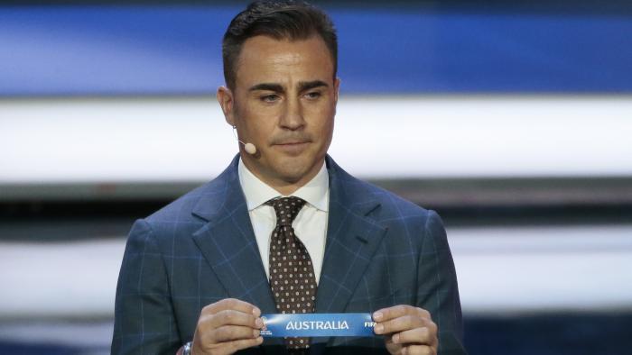 Former Italian soccer international Fabio Cannavaro holds up the team name of Australia the 2018 soccer World Cup draw in the Kremlin in Moscow, Friday, Dec. 1, 2017. (AP Photo/Ivan Sekretarev)