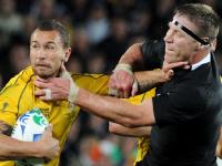 Wallabies Quade Cooper (L) is tackled All Blacks Brad Thorn during New Zealand v Australia 2011 Rugby World Cup (RWC) semi-final match at Eden Park Stadium in Auckland, 16/10/2011.