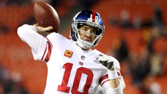 (FILES) This file photo taken on November 22, 2017 shows Quarterback Eli Manning #10 of the New York Giants warming up before the start of the Giants game against the Washington Redskins at FedExField in Landover, Maryland. Eli Manning's run of 210 straight regular-season starts for the New York Giants will end December 3, 2017 when the struggling NFL team starts Geno Smith at quarterback against the Oakland Raiders."Geno will start this week," Giants coach Ben McAdoo said November 28, 2017, adding that over the final five games of the season the team would also give rookie quarterback Davis Webb a try. / AFP PHOTO / GETTY IMAGES NORTH AMERICA / Rob Carr