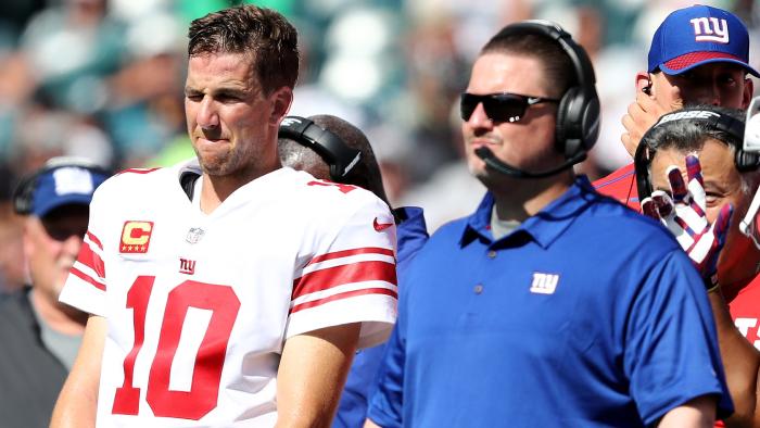 (FILES) This file photo taken on September 23, 2017 shows Eli Manning #10 of the New York Giants and head coach Ben McAdoo waiingt for the review on a touchdown scored in the second quarter by the New York Giants at Lincoln Financial Field in Philadelphia, Pennsylvania. The New York Giants fired head coach Ben McAdoo on December 4, 2017, less than a week after he triggered uproar by benching long-serving quarterback Eli Manning, reports said.The Giants general manager Jerry Reese has also been dismissed after an 11-year reign which yielded two Super Bowls.McAdoo's position has been under scrutiny all season after a series of dismal performances that have left the Giants with a 2-10 record, tied for second worst in the league. / AFP PHOTO / GETTY IMAGES NORTH AMERICA / ELSA