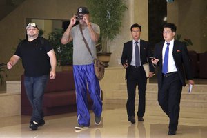 File - Former NBA basketball star Dennis Rodman, second from left, walks through the Koryo hotel lobby as he leaves to visit several sports venues Wednesday, June 14, 2017, in Pyongyang, North Korea.