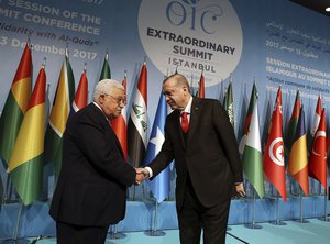 Turkey's President Recep Tayyip Erdogan, right, shakes hands with Palestinian President Mahmoud Abbas, left, following the closing news conference after the Organisation of Islamic Cooperation's Extraordinary Summit in Istanbul, Wednesday, Dec. 13, 2017.